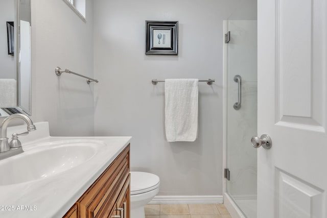 bathroom featuring a shower with door, vanity, tile patterned floors, and toilet