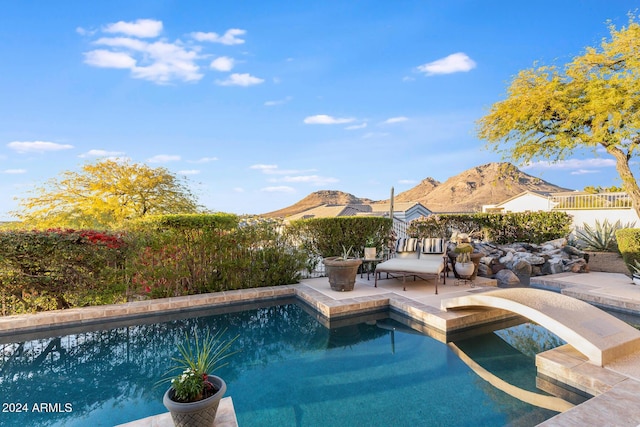 view of pool featuring a mountain view and a patio