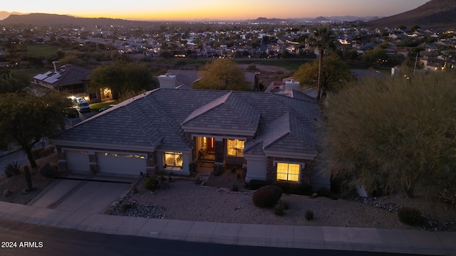 view of front of home with a mountain view and a garage