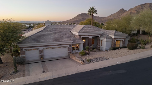 ranch-style house with a mountain view and a garage