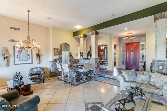 living room with light tile patterned floors and ceiling fan with notable chandelier