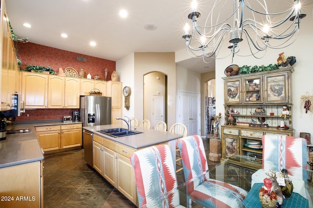 kitchen featuring sink, an inviting chandelier, pendant lighting, light brown cabinetry, and appliances with stainless steel finishes