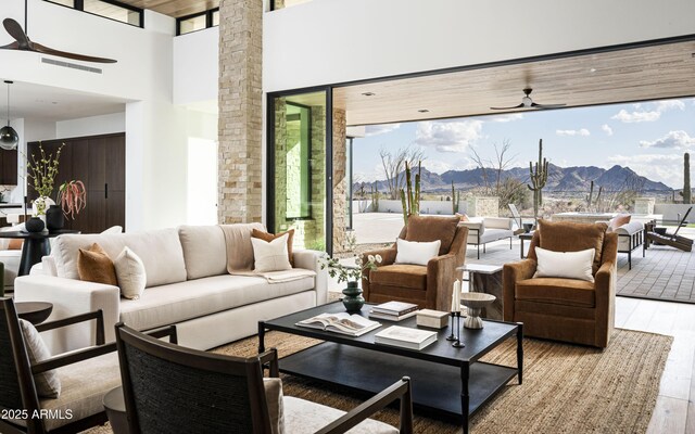 unfurnished living room with a towering ceiling, wooden ceiling, and light hardwood / wood-style flooring