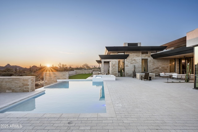 28805 N 114th St, Scottsdale, AZ 85262 - pool at dusk featuring an outdoor hangout area, an outdoor pool, and a patio area
