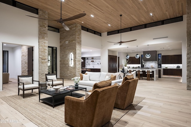 28805 N 114th St, Scottsdale, AZ 85262 - living room featuring ceiling fan, light wood-type flooring, wood ceiling, and a towering ceiling