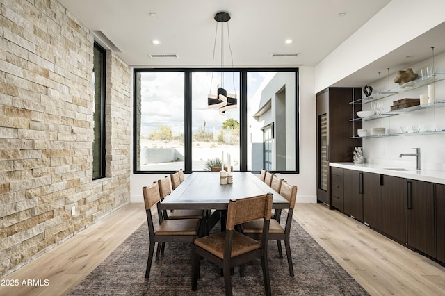 28805 N 114th St, Scottsdale, AZ 85262 - dining room featuring brick wall, light wood-style floors, and visible vents