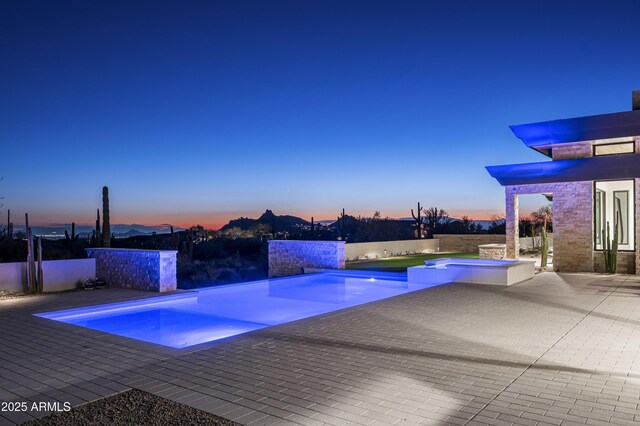 pool at dusk with a patio