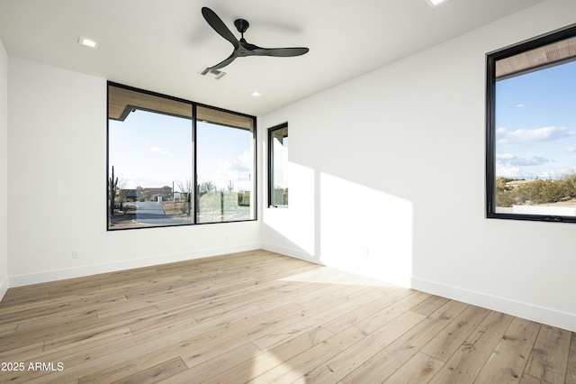 empty room with light hardwood / wood-style flooring and ceiling fan