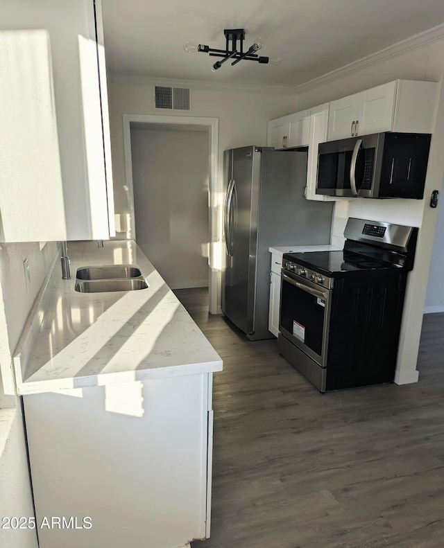 3421 W Montecito Ave, Phoenix, AZ 85017 - kitchen featuring stainless steel appliances, white cabinets, ornamental molding, wood finished floors, and light stone counters