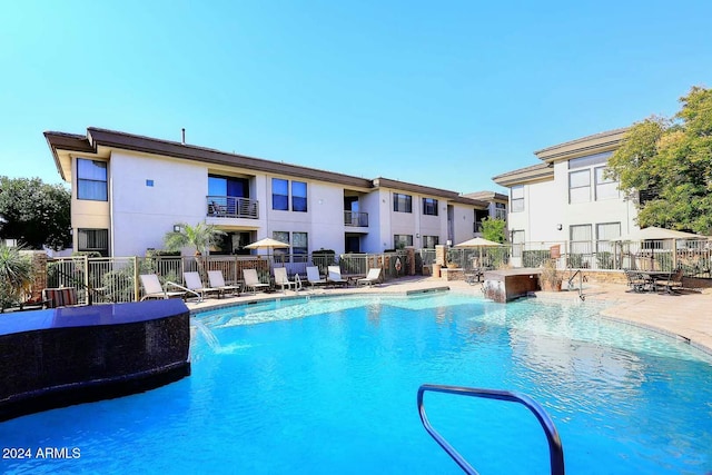 view of swimming pool with pool water feature