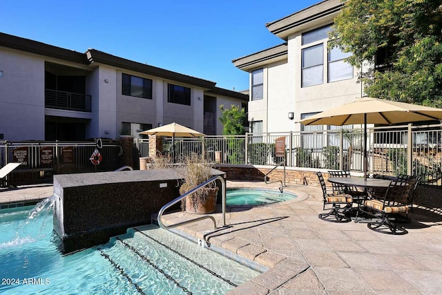 view of pool with a community hot tub