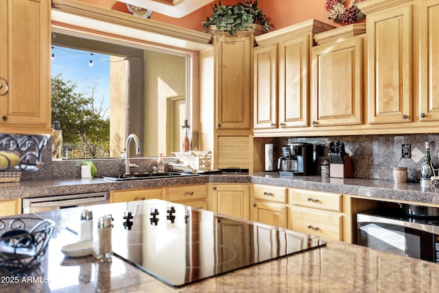 kitchen featuring dishwasher, black electric stovetop, sink, light brown cabinetry, and tasteful backsplash