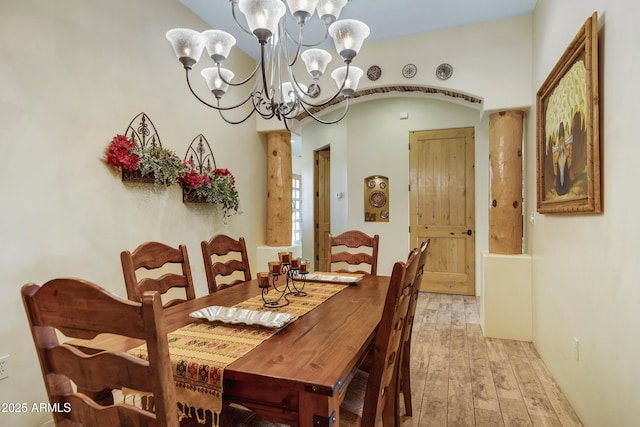 dining area with a chandelier and light hardwood / wood-style floors