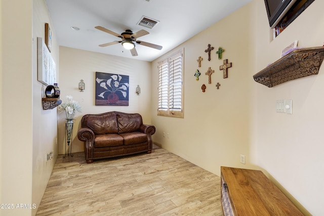 sitting room featuring ceiling fan and light hardwood / wood-style floors