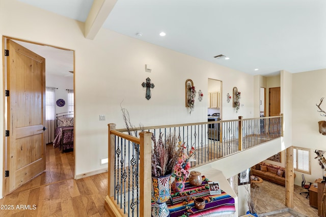 hallway featuring beam ceiling and wood-type flooring