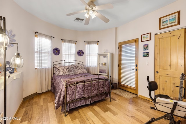 bedroom featuring multiple windows, ceiling fan, and light hardwood / wood-style floors