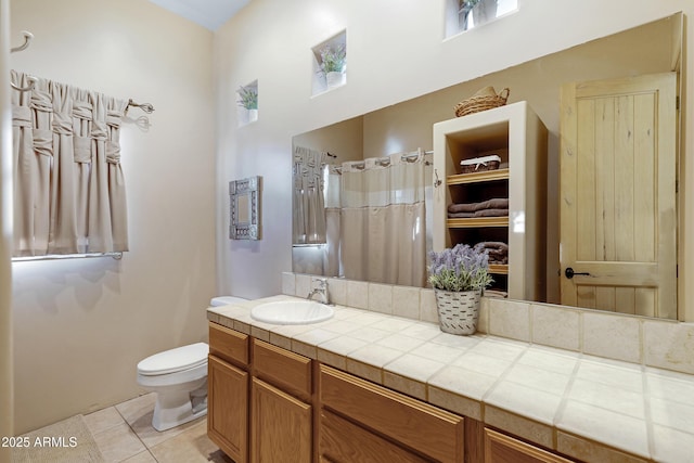 bathroom with tile patterned flooring, vanity, curtained shower, and toilet