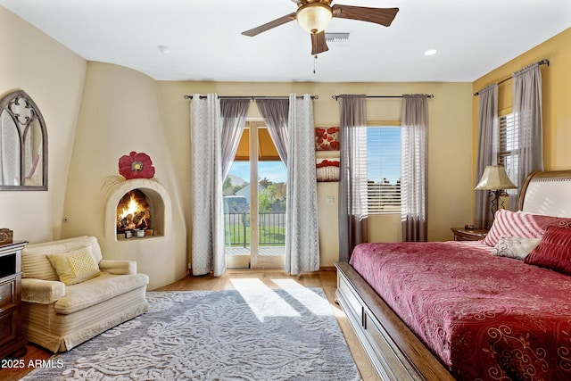 bedroom with access to outside, ceiling fan, and light hardwood / wood-style flooring