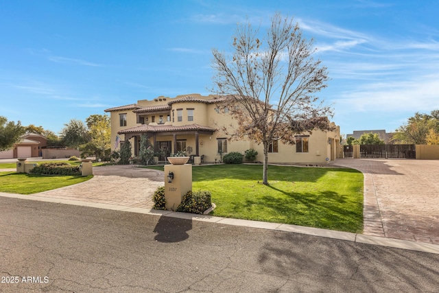 mediterranean / spanish home featuring a front lawn