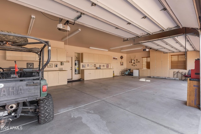 garage featuring a garage door opener and water heater