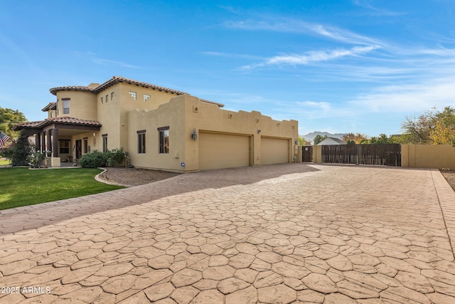 view of property exterior with a garage and a lawn