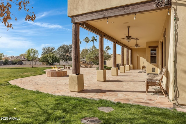 view of patio with a fire pit and ceiling fan