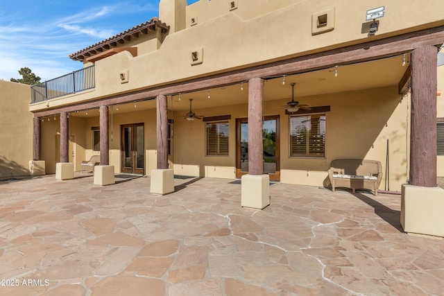 rear view of property featuring a patio, a balcony, and ceiling fan