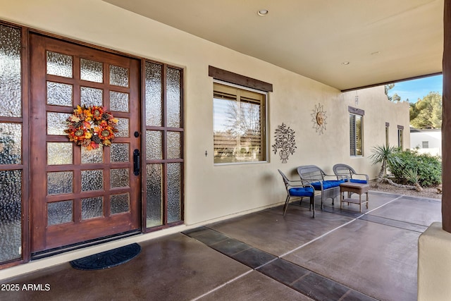 view of exterior entry featuring a patio area and french doors