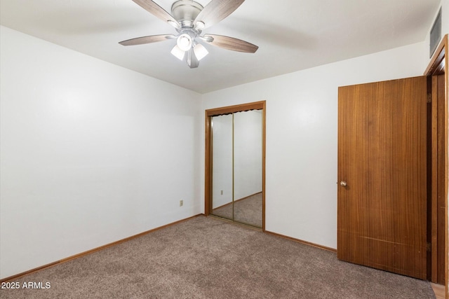 unfurnished bedroom featuring a closet, baseboards, carpet, and ceiling fan