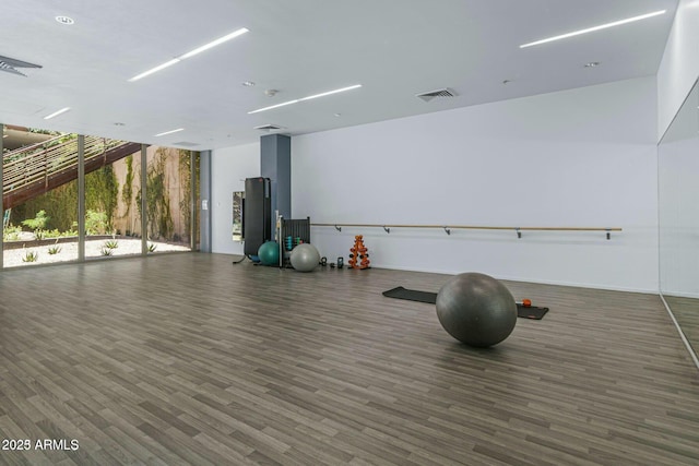 workout area featuring visible vents and wood finished floors