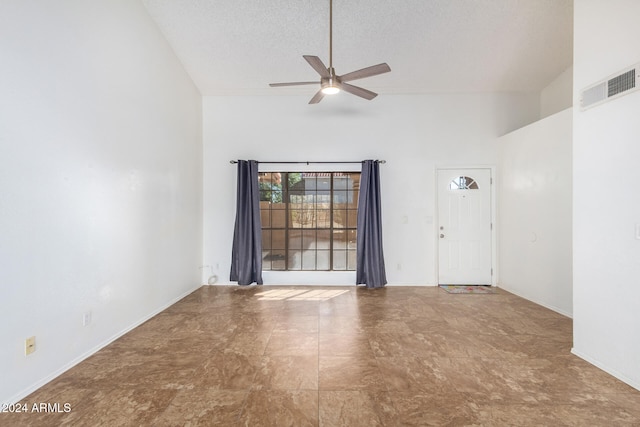 empty room featuring high vaulted ceiling, a textured ceiling, and ceiling fan