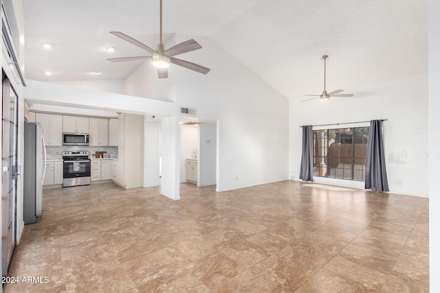 unfurnished living room featuring high vaulted ceiling and ceiling fan