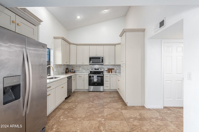 kitchen with high vaulted ceiling, backsplash, appliances with stainless steel finishes, and sink