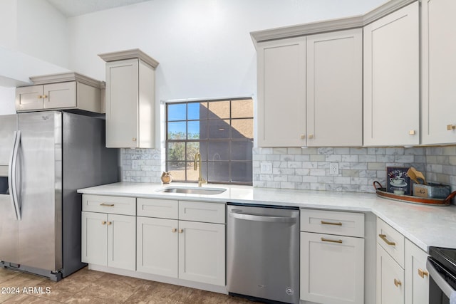 kitchen with stainless steel appliances, sink, and tasteful backsplash