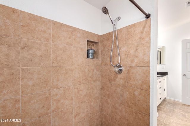 bathroom featuring vanity and a tile shower