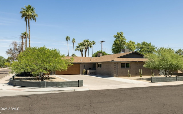 8502 E Rose Ln, Scottsdale, AZ 85250 - single story home featuring a garage, concrete driveway, and brick siding