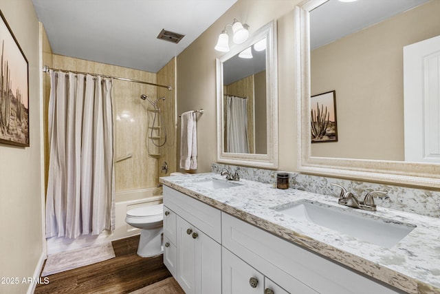 8502 E Rose Ln, Scottsdale, AZ 85250 - full bath with double vanity, wood finished floors, shower / bathtub combination with curtain, and toilet