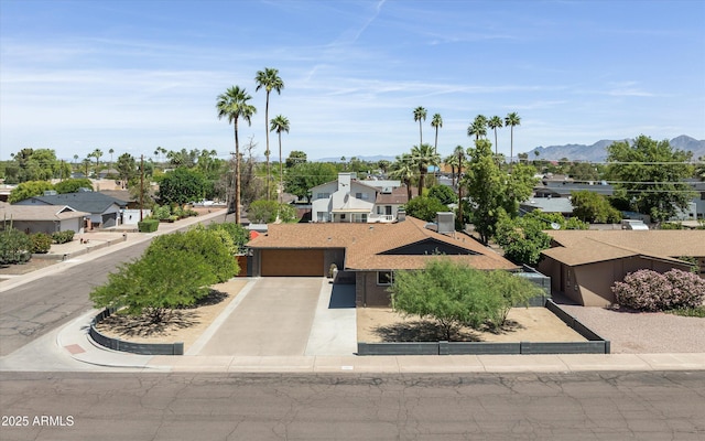 8502 E Rose Ln, Scottsdale, AZ 85250 - view of front of property featuring a residential view, concrete driveway, a garage, and a mountain view