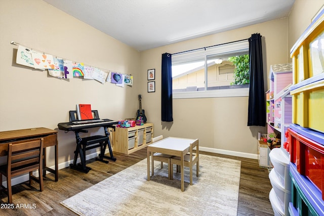 8502 E Rose Ln, Scottsdale, AZ 85250 - game room featuring plenty of natural light, wood finished floors, and baseboards