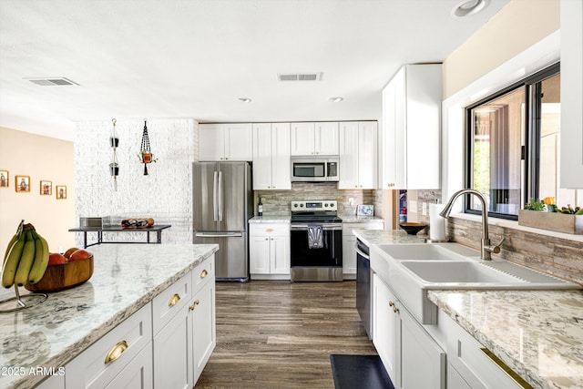 8502 E Rose Ln, Scottsdale, AZ 85250 - kitchen with stainless steel appliances, a sink, tasteful backsplash, white cabinets, and recessed lighting