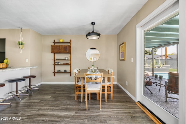 8502 E Rose Ln, Scottsdale, AZ 85250 - dining area with dark wood-type flooring and baseboards