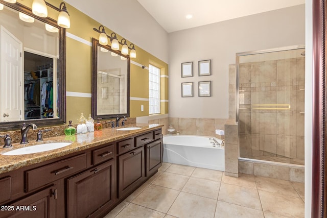 6719 N 15th Ave, Phoenix, AZ 85015 - full bathroom featuring tile patterned floors, a stall shower, a garden tub, double vanity, and a walk in closet