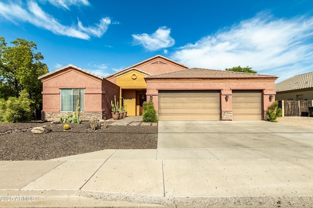 6719 N 15th Ave, Phoenix, AZ 85015 - ranch-style home with stucco siding, an attached garage, concrete driveway, and stone siding