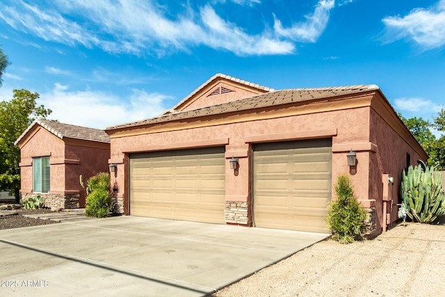 6719 N 15th Ave, Phoenix, AZ 85015 - view of front of house with stucco siding, driveway, stone siding, and an attached garage