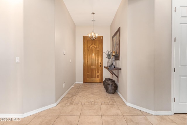 6719 N 15th Ave, Phoenix, AZ 85015 - foyer with light tile patterned floors, a chandelier, and baseboards