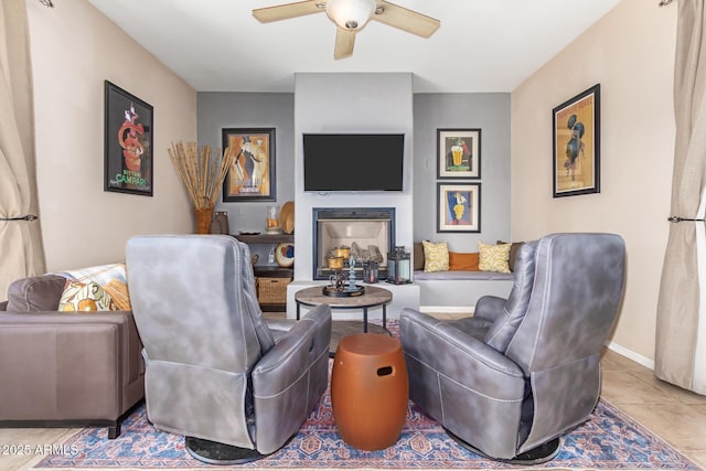 6719 N 15th Ave, Phoenix, AZ 85015 - tiled living room featuring a ceiling fan, a fireplace, and baseboards