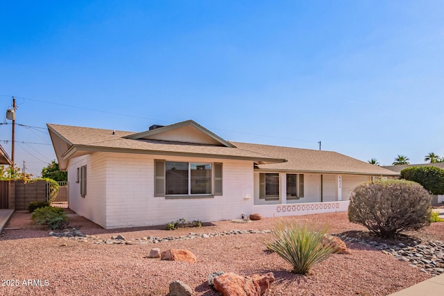 ranch-style house with brick siding and fence