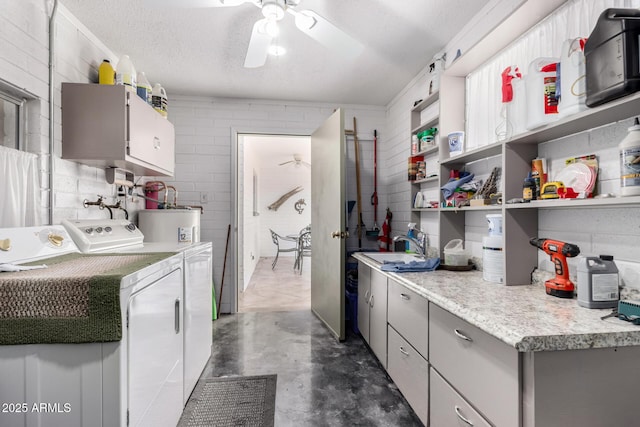 kitchen featuring washer and clothes dryer, gray cabinets, concrete flooring, electric water heater, and light countertops