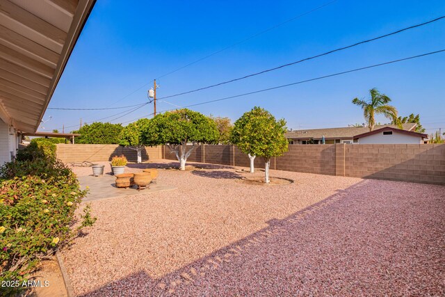 fenced backyard with a patio