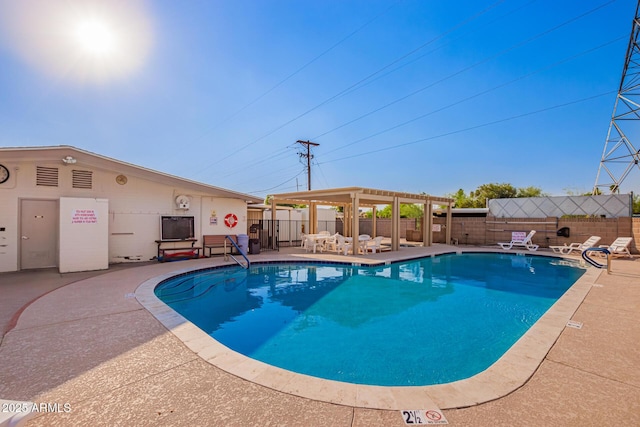 community pool featuring fence and a patio area